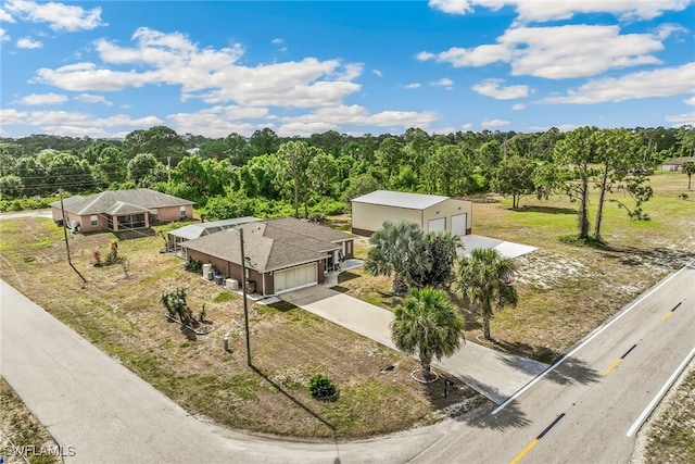 705 Columbus Blvd S, Lehigh Acres, FL 33974 - aerial view of property and surrounding area featuring a heavily wooded area