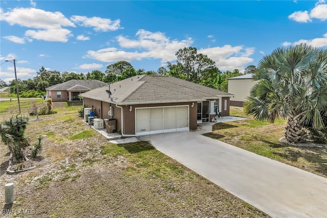 705 Columbus Blvd S, Lehigh Acres, FL 33974 - view of front of house featuring concrete driveway, a garage, stucco siding, and a shingled roof