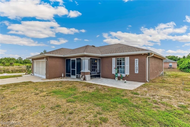 705 Columbus Blvd S, Lehigh Acres, FL 33974 - rear view of house featuring driveway, an attached garage, a yard, and stucco siding