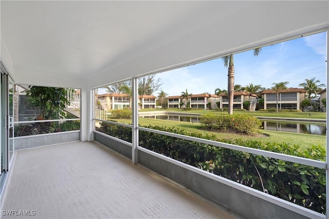1155 Sandpiper St Unit E1, Naples, FL 34102 - unfurnished sunroom featuring a water view and a residential view