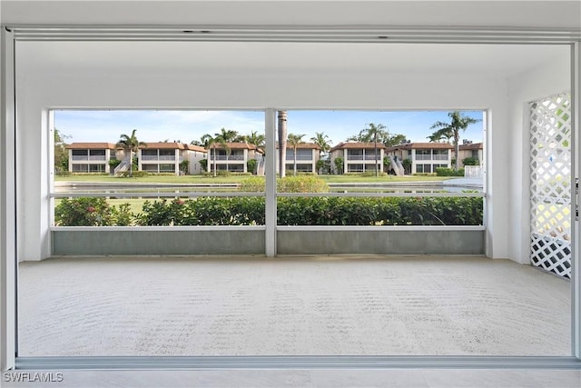 1155 Sandpiper St Unit E1, Naples, FL 34102 - unfurnished sunroom featuring a residential view