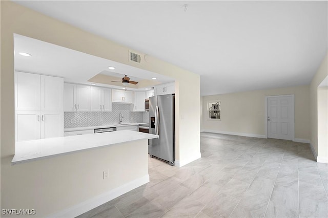 1155 Sandpiper St Unit E1, Naples, FL 34102 - kitchen with appliances with stainless steel finishes, a peninsula, light countertops, white cabinets, and ceiling fan