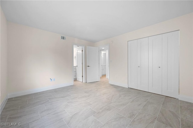 1155 Sandpiper St Unit E1, Naples, FL 34102 - unfurnished bedroom with a closet and ensuite bathroom