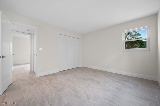 1155 Sandpiper St Unit E1, Naples, FL 34102 - unfurnished bedroom with baseboards and a closet