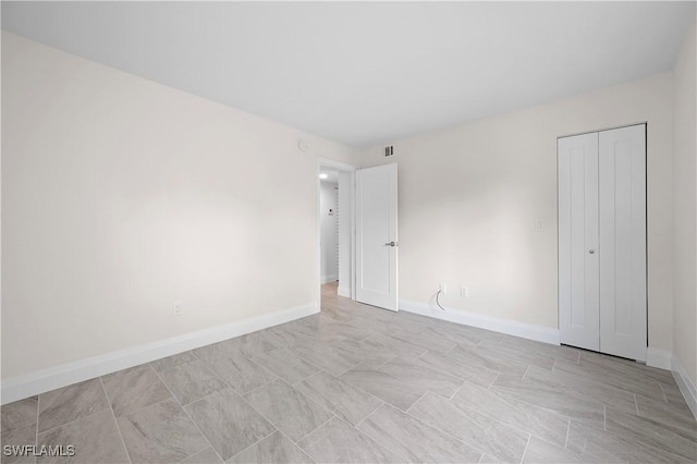 1155 Sandpiper St Unit E1, Naples, FL 34102 - unfurnished bedroom with baseboards and a closet