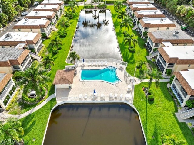 1155 Sandpiper St Unit E1, Naples, FL 34102 - drone / aerial view of a pool and a nearby body of water
