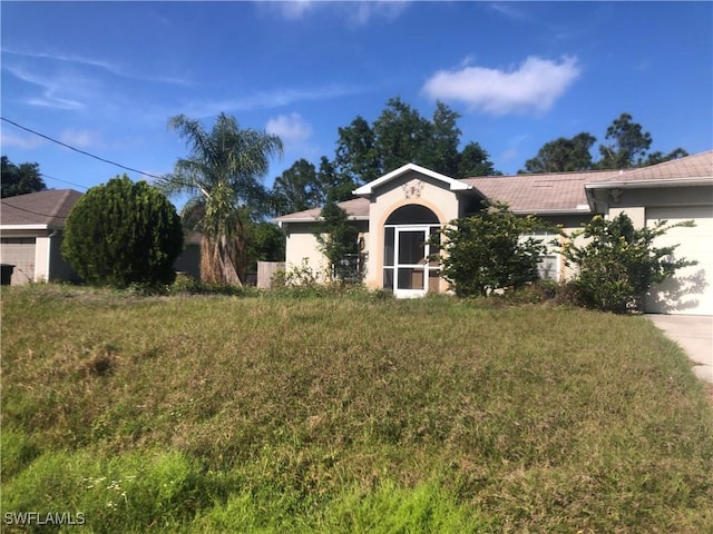single story home with stucco siding, driveway, and a garage