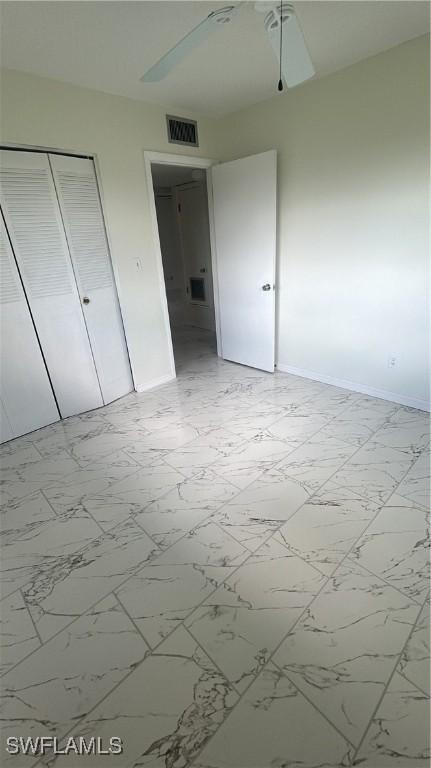 2213 Gardenia Way, Lehigh Acres, FL 33936 - unfurnished bedroom featuring baseboards, visible vents, marble finish floor, and a closet