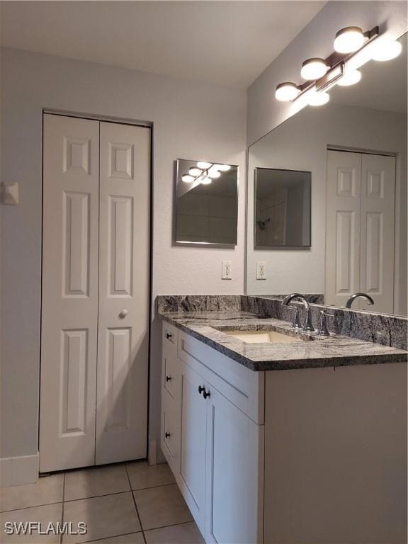 bathroom featuring a closet, tile patterned flooring, and vanity