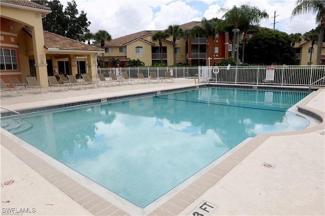 pool with fence and a patio