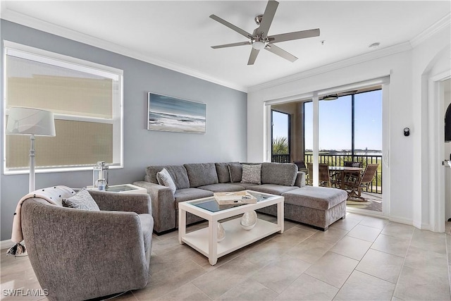 living room featuring a ceiling fan, crown molding, and baseboards