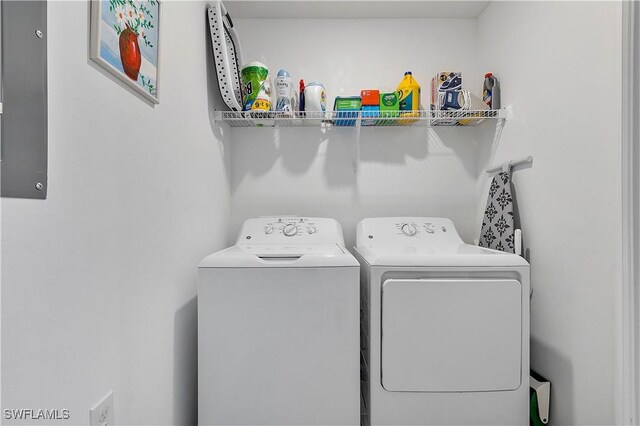 clothes washing area with washing machine and clothes dryer and laundry area
