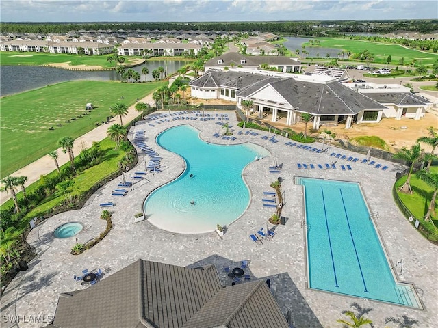 view of swimming pool featuring golf course view, a residential view, and a water view