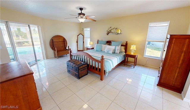 bedroom with light tile patterned floors, a ceiling fan, access to outside, and baseboards