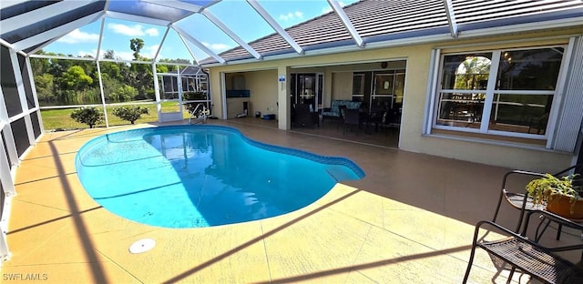 pool with a lanai and a patio area