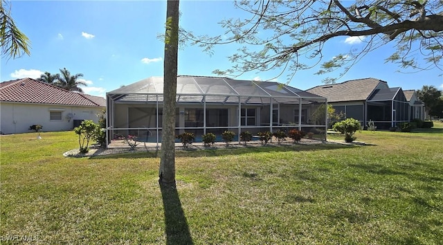 rear view of property featuring a lawn