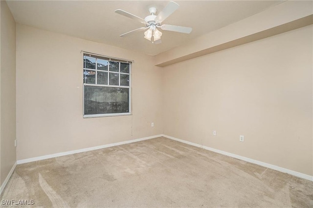 unfurnished room featuring carpet flooring, ceiling fan, and baseboards