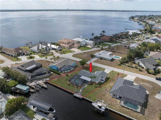 bird's eye view with a water view and a residential view