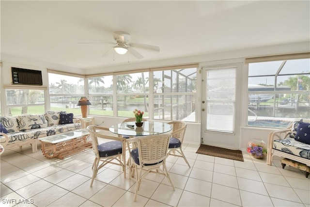 sunroom featuring a water view and tile patterned flooring