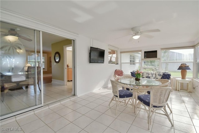 dining room featuring light tile patterned floors, ceiling fan, and baseboards
