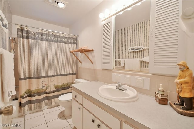 full bath with decorative backsplash, a shower with curtain, toilet, tile patterned floors, and vanity