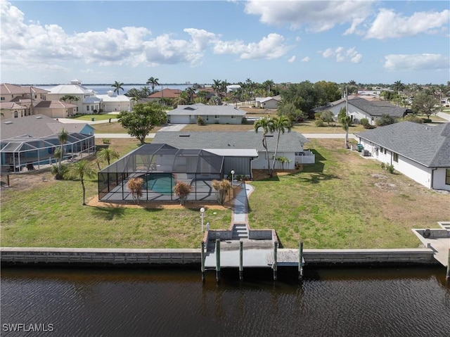drone / aerial view featuring a residential view and a water view