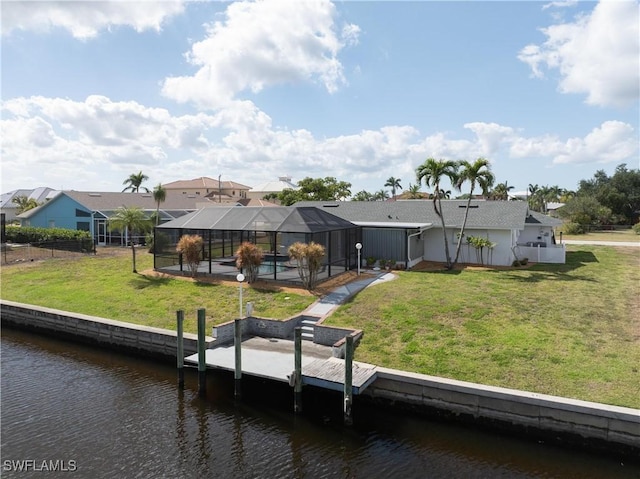 rear view of house featuring glass enclosure, a swimming pool, a water view, and a lawn