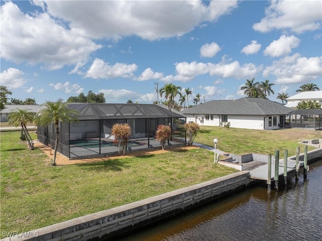 back of house featuring a patio area, an outdoor pool, a water view, and a lawn