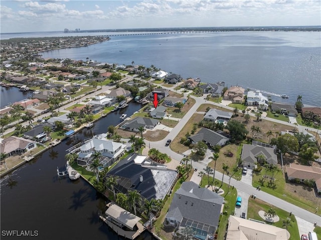 drone / aerial view with a residential view and a water view