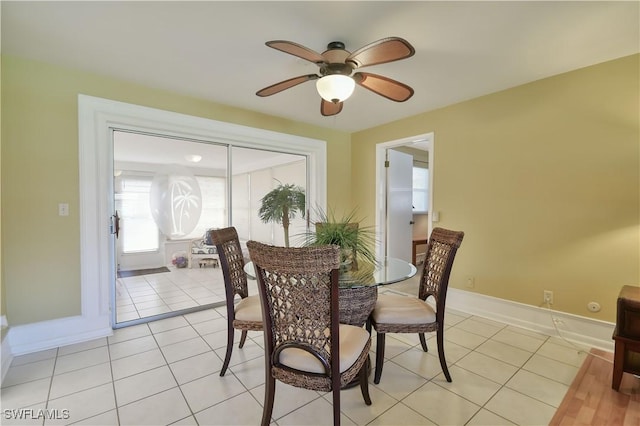 dining room featuring light tile patterned floors, a ceiling fan, and baseboards