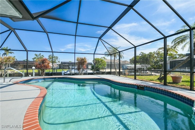 outdoor pool with a patio and glass enclosure