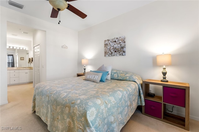 14524 Abaco Lakes Dr Unit 203, Fort Myers, FL 33908 - bedroom featuring connected bathroom, visible vents, a sink, and carpet floors