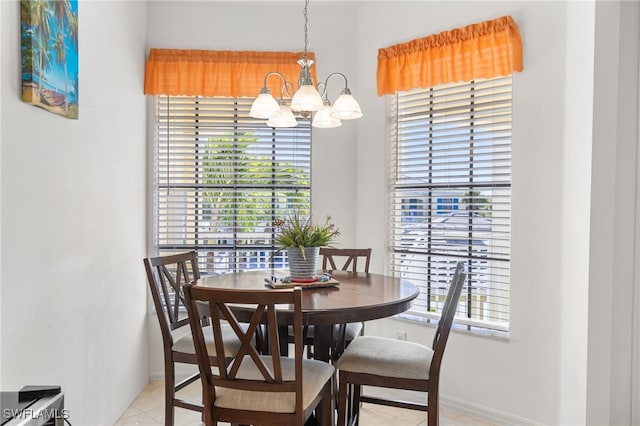 14524 Abaco Lakes Dr Unit 203, Fort Myers, FL 33908 - dining area with a chandelier, baseboards, and light tile patterned floors