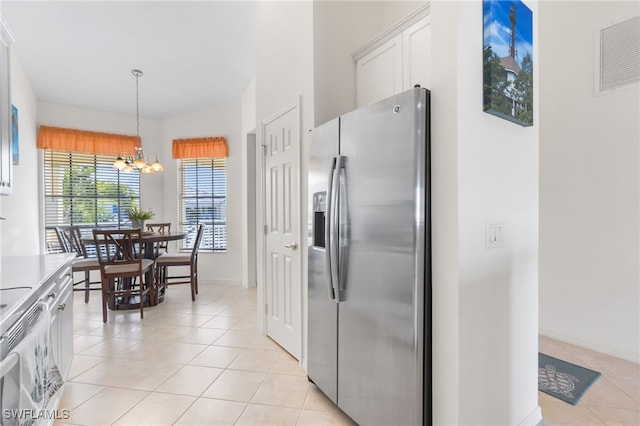 14524 Abaco Lakes Dr Unit 203, Fort Myers, FL 33908 - kitchen featuring stainless steel refrigerator with ice dispenser, visible vents, a chandelier, light tile patterned floors, and white cabinets