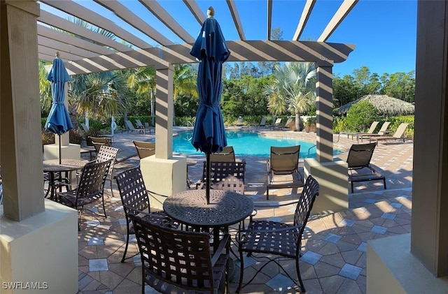 14524 Abaco Lakes Dr Unit 203, Fort Myers, FL 33908 - view of patio featuring a pergola and a community pool