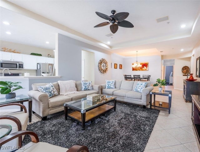 4630 Winged Foot Ct Unit 202, Naples, FL 34112 - living room with recessed lighting, light tile patterned floors, ceiling fan with notable chandelier, and a tray ceiling