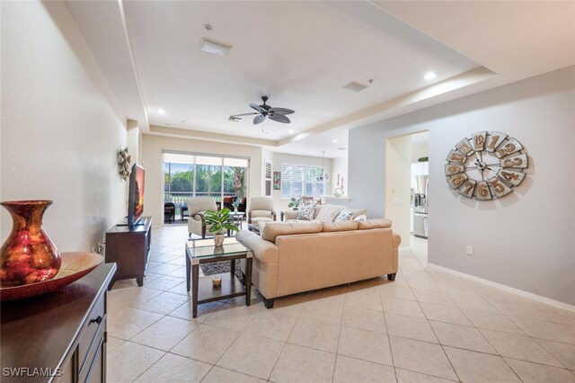 4630 Winged Foot Ct Unit 202, Naples, FL 34112 - living area featuring a raised ceiling, ceiling fan, light tile patterned floors, and baseboards