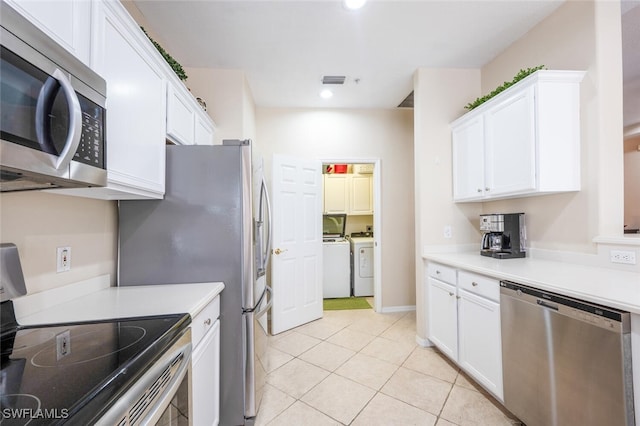 4630 Winged Foot Ct Unit 202, Naples, FL 34112 - kitchen featuring separate washer and dryer, white cabinetry, and stainless steel appliances