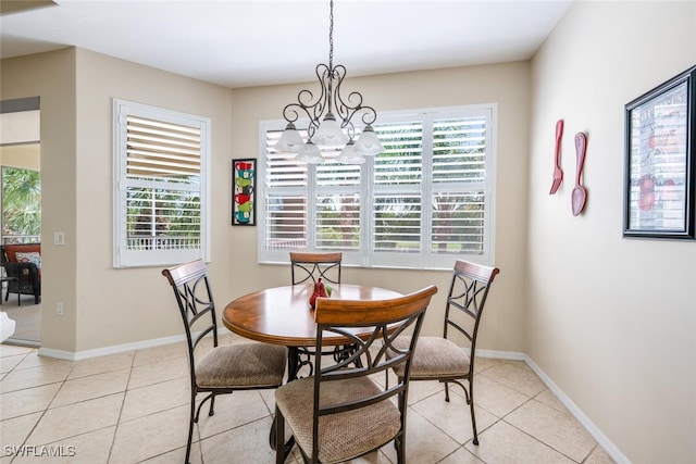 4630 Winged Foot Ct Unit 202, Naples, FL 34112 - dining area with light tile patterned floors, a chandelier, and plenty of natural light