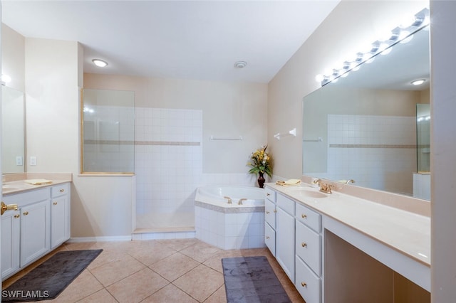 4630 Winged Foot Ct Unit 202, Naples, FL 34112 - full bathroom with a walk in shower, two vanities, a bath, and tile patterned flooring