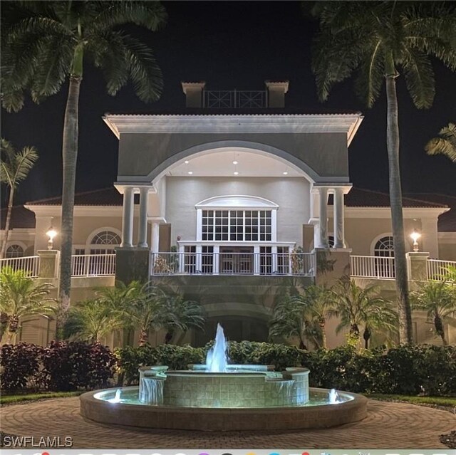 4630 Winged Foot Ct Unit 202, Naples, FL 34112 - back of house at night with stucco siding