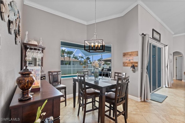 2640 SW 29th Ave, Cape Coral, FL 33914 - dining room featuring a chandelier, ornamental molding, arched walkways, light tile patterned floors, and baseboards