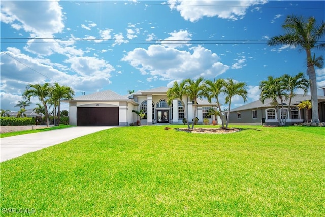 2640 SW 29th Ave, Cape Coral, FL 33914 - mediterranean / spanish home featuring a front yard, driveway, stucco siding, a garage, and french doors