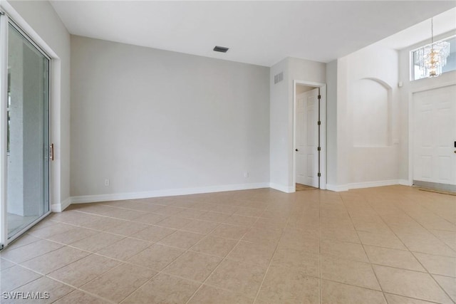4220 12th Ave SE, Naples, FL 34117 - spare room featuring an inviting chandelier, light tile patterned floors, and visible vents