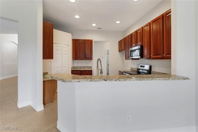 4220 12th Ave SE, Naples, FL 34117 - kitchen featuring light stone countertops, a peninsula, stainless steel appliances, and light tile patterned floors