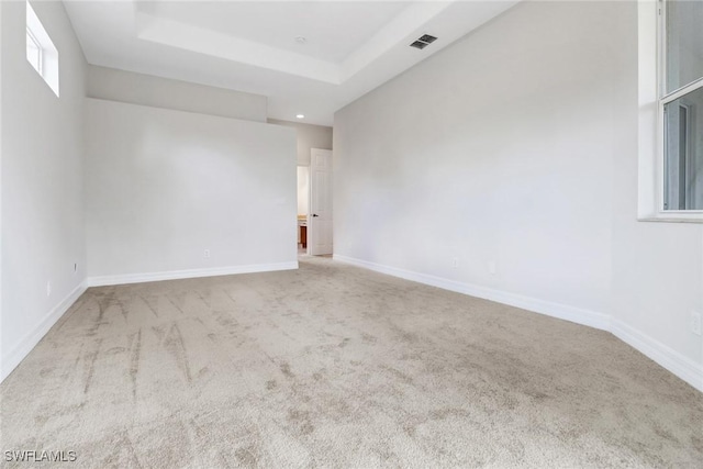 4220 12th Ave SE, Naples, FL 34117 - carpeted spare room featuring a raised ceiling, baseboards, and visible vents