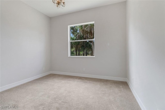 4220 12th Ave SE, Naples, FL 34117 - spare room with carpet, a chandelier, and baseboards