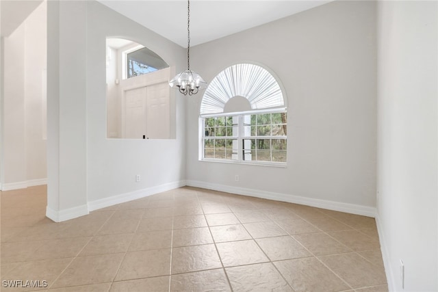 4220 12th Ave SE, Naples, FL 34117 - unfurnished dining area with an inviting chandelier, a wealth of natural light, tile patterned flooring, and baseboards