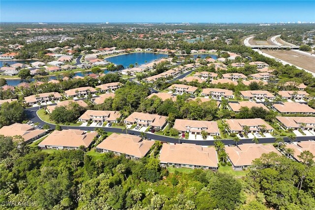 birds eye view of property featuring a water view and a residential view
