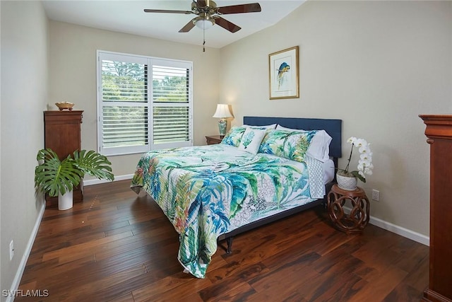 bedroom with wood finished floors, a ceiling fan, and baseboards
